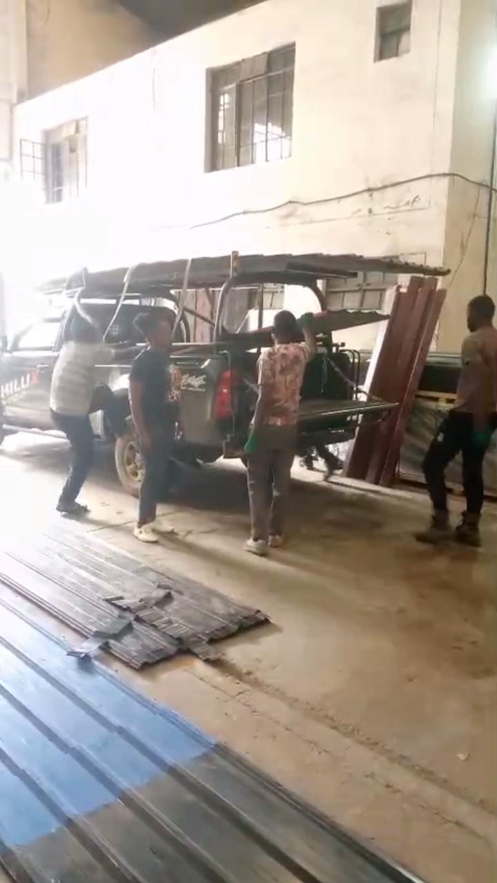 Team loading mabati onto truck for delivery